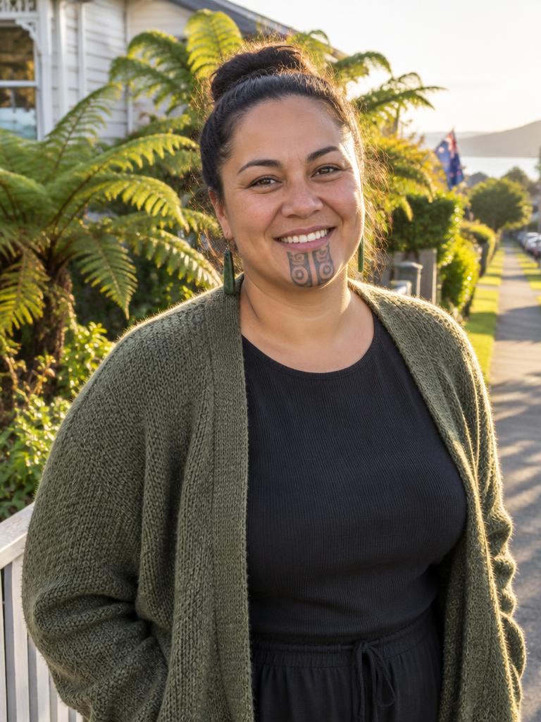 A Maori New Zealand woman in her mid-thirties smiling on a sunny suburban street